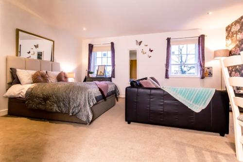 a bedroom with a bed and a chair at Domus House Studio Apartments in Chester city centre with Free Parking by Rework Accommodation in Chester