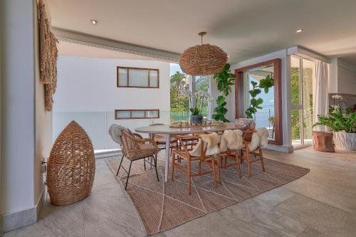 a dining room with a table and chairs at Maxwell Residences at Indah in Puerto Vallarta