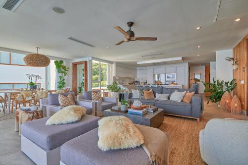 a living room with couches and a dining room at Maxwell Residences at Indah in Puerto Vallarta