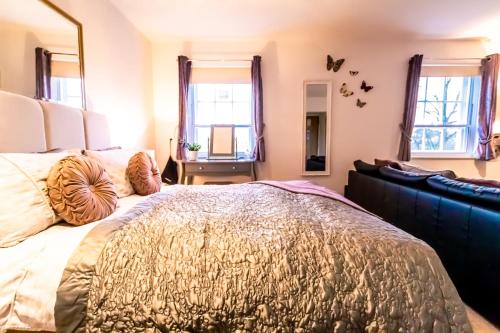 a bedroom with a large bed and a mirror at Domus House Studio Apartments Chester city centre by Rework Accommodation in Chester