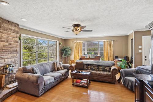 ein Wohnzimmer mit 2 Sofas und einer Ziegelwand in der Unterkunft Mid-Century Vintage Brick Ranch Upstairs Guesthouse in Sevierville