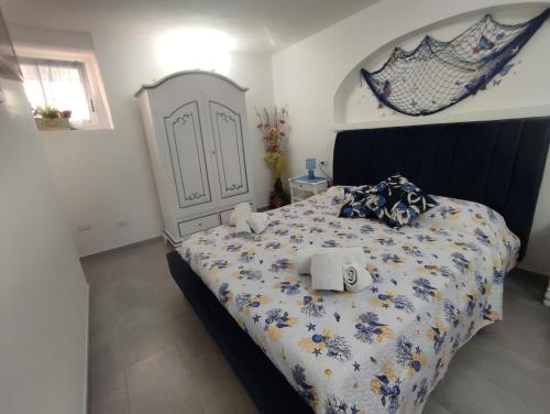 una camera da letto con un grande letto con una grande testiera di B&B Dal Duca Enrico a Castelsardo