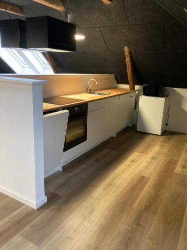 a kitchen with white cabinets and a sink at Signinn in Varde
