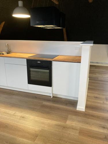 a kitchen counter with a microwave on top of it at Signinn in Varde