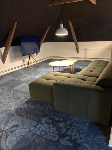 a living room with a couch and a table at Signinn in Varde