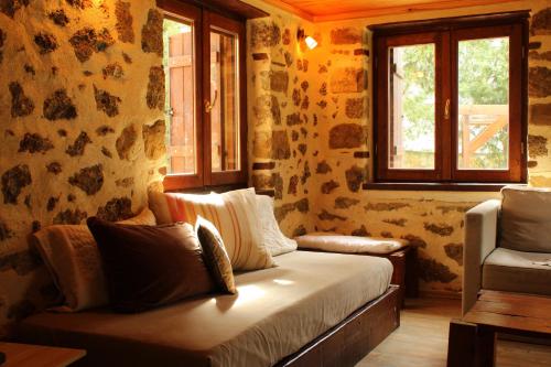 a living room with a couch and a window at Εν Αρχή - En Arhi in Ano Trikala