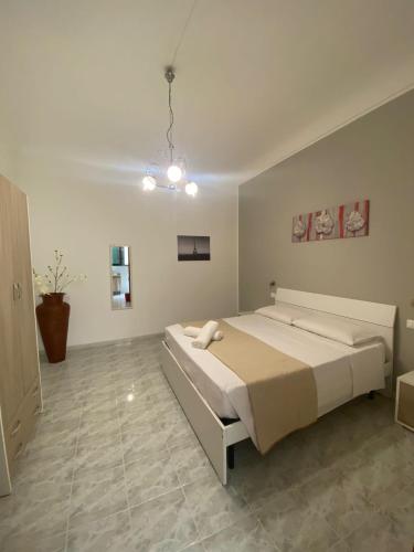 a bedroom with a large bed in a room at Apartment Roasi in Trapani