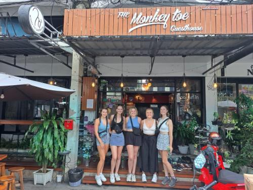 a group of people standing in front of a store at Monkey Toe Guesthouse in Chiang Mai