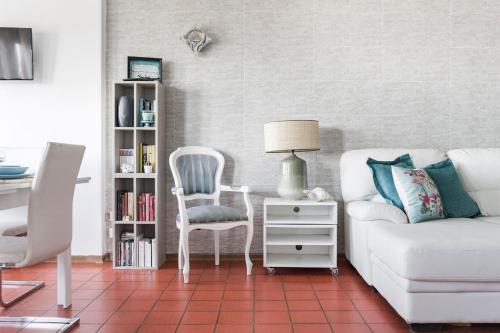 a living room with a couch and a chair at Seafront House Free Parking AC in Alba Adriatica