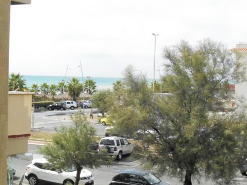 a view of a parking lot with cars parked at Casa Sista in Lido di Ostia
