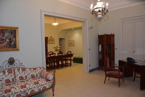 a living room with a couch and a dining room at B&B Villa Maria in Giarre