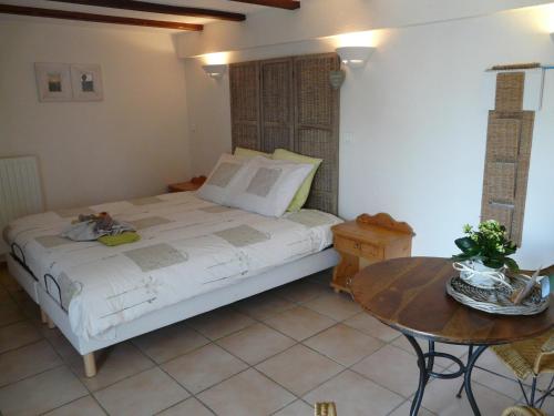 une chambre avec un lit et une table dedans dans l'établissement Chambre d'hotes grange de la bastide, à Laveissière