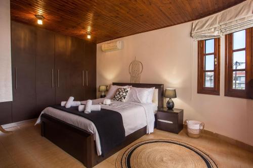 a bedroom with a large bed and a wooden ceiling at Hriska Luxury Villa in Ixia