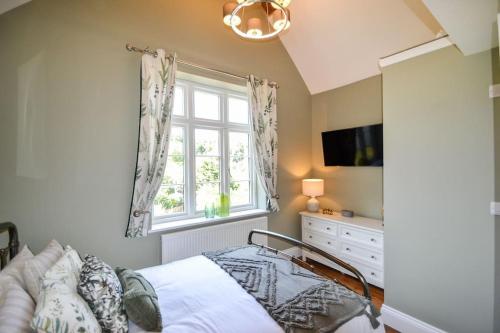 a bedroom with a bed and a window at The Engine House, 36 Coalford in Ironbridge