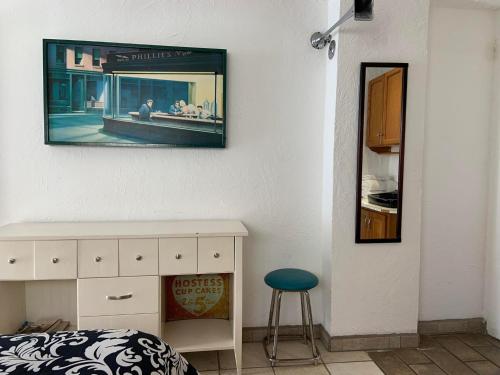 a bedroom with a bed and a picture on the wall at Poco Cielo Hotel in Rosarito