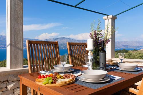 a wooden table with a plate of food on it at House Marina in Postira