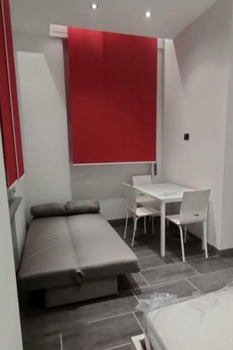 a room with a bed and two chairs and a table at VIGEVANO LA STAZIONE in Vigevano