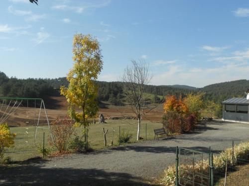 a view of a field with trees and a building at Chez Louis chambres d'hôtes à la ferme in La Canourgue