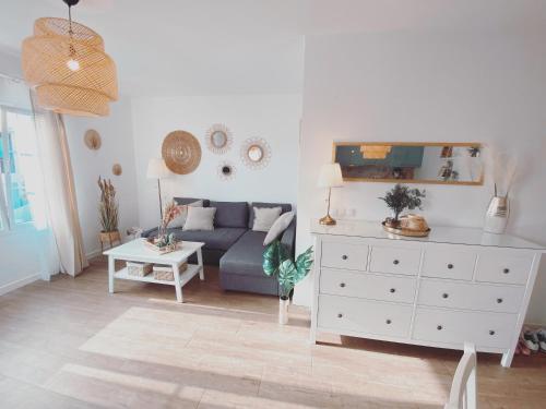 a living room with a blue couch and a white dresser at Casa Rosalia Puerto del Carmen in Puerto del Carmen