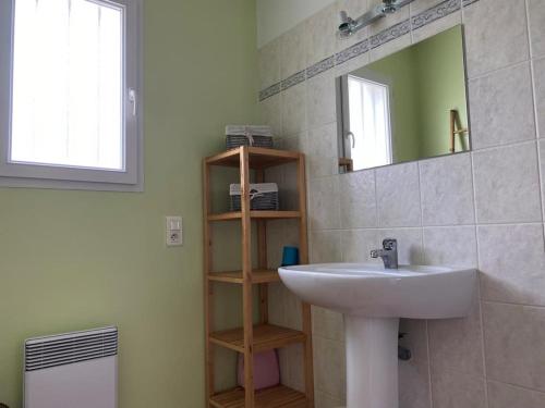 une salle de bain avec un lavabo et un miroir dans l'établissement Séjour au cœur de Jard-sur-Mer : Maison avec terrasse et garage près de la plage ! - FR-1-336-125, à Jard-sur-Mer