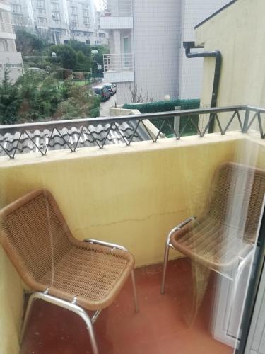 two chairs and a table on a balcony at Alojamento Local Casa Veras in Vila Real