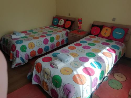 a bedroom with two beds with polka dot sheets at Alojamento Local Casa Veras in Vila Real