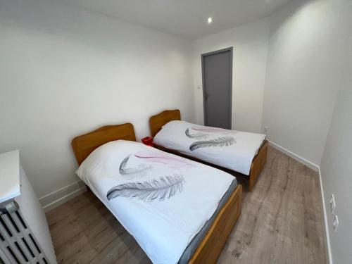 Ένα ή περισσότερα κρεβάτια σε δωμάτιο στο Appartement de la laverie