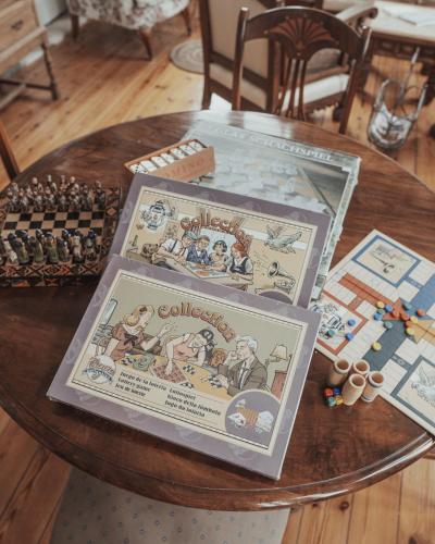 a wooden table with a board game on it at La Venta de Miyares - Casa de Indianos in Piloña