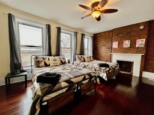 a bedroom with two beds and a ceiling fan at Downtown Loft Sleeps 6 - Pool Table Shuffleboard in Louisville