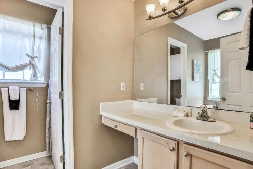 a bathroom with a sink and a mirror at White House Home in St. Augustine