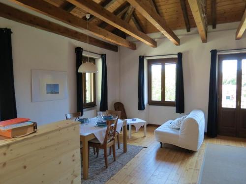 a living room with a table and a dining room at Appartamento AQUILONE in Mergozzo