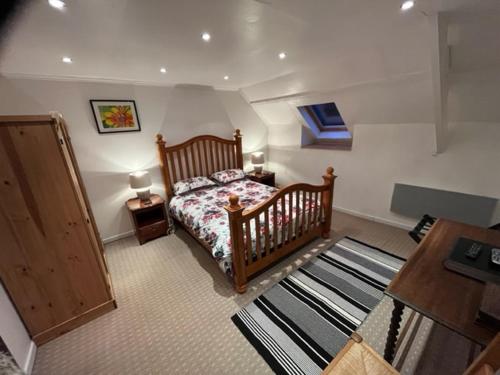 a bedroom with a bed and a desk and a table at Chez Thomas 7 Route du Monde Ancien in Saint-Georges-dʼAunay