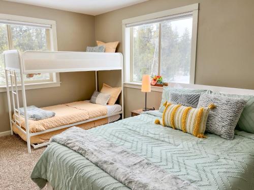 a bedroom with a bed and a bunk bed at Yellowstone Getaway in Beautiful Box Canyon in Island Park