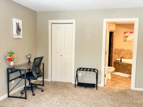 an office with a desk and a chair and a bathroom at Yellowstone Getaway in Beautiful Box Canyon in Island Park