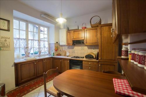 una cocina con armarios de madera y una mesa de madera con una mesa de madera. en Giò's House vintage style, en Stresa