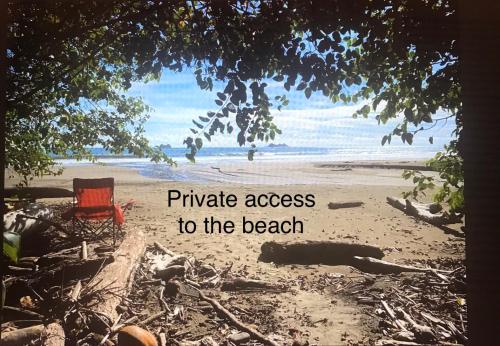 a picture of a beach with a chair on the beach at hotelsonidosamados-osa in Sierpe