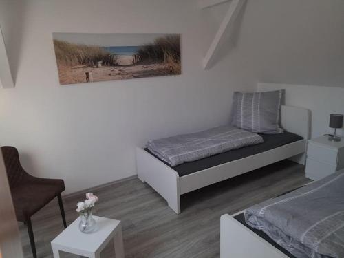 a small bedroom with a bed and a chair at Willkommen in Weisenheim am Sand in Weisenheim am Sand