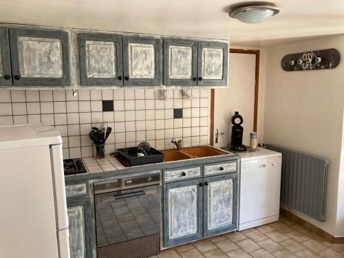 a kitchen with a sink and a counter top at Gîte L'hirondelle in Meyrueis