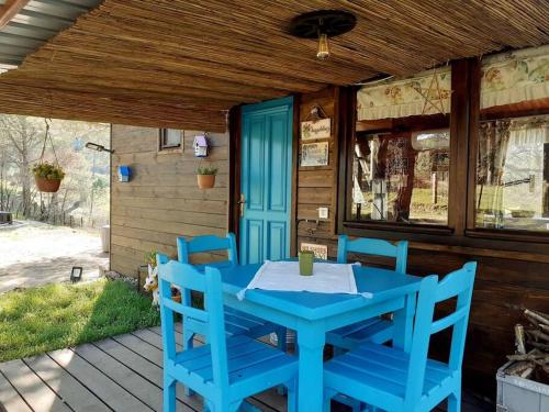 a blue table and chairs on the porch of a house at Kozalak Bungalov Kozak Yaylası in Çamoba