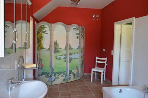 a bathroom with a painting on the wall at Marstall Gut Güldenstein Ganzes Haus 13 Pers Kamin in Harmsdorf