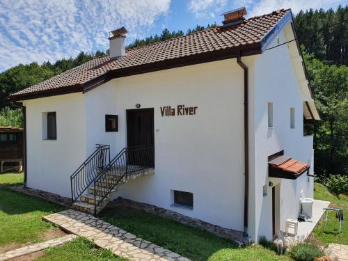 a small white building with a door with the words wine mixer at Villa River Pehchevo in Pehčevo