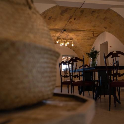 a dining room with a table and chairs and a chandelier at Casale Ferrantino in Giulianova