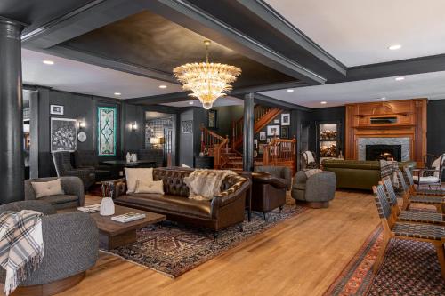 a living room with leather furniture and a chandelier at The Wentworth in Jackson