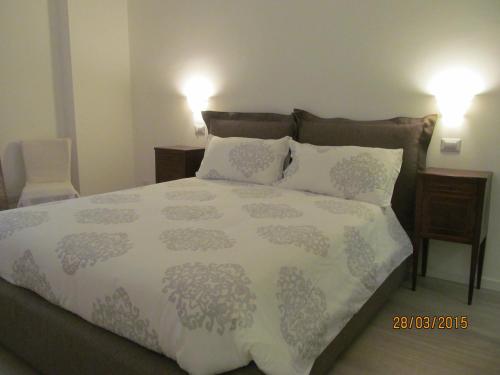 a bedroom with a large bed with two pillows at Vicolo Chiodo in Verona