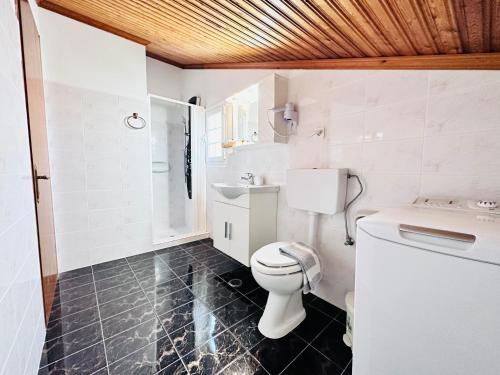 a bathroom with a toilet and a sink at Nikos Apartments Corfu in Agios Stefanos