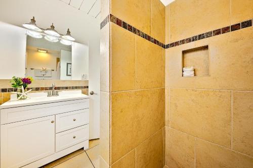 a bathroom with a sink and a large mirror at OB Pier 1 in San Diego