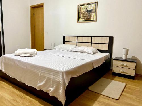 a bed with two pillows on it in a bedroom at SKY Modern 1 BR APT w free parking in Bucharest