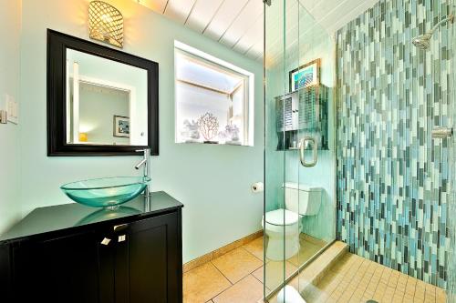 a bathroom with a sink and a glass shower at OB Pier 2 in San Diego