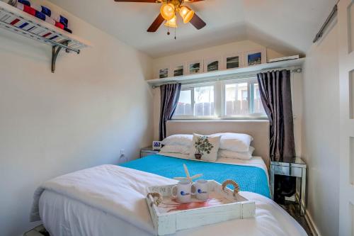 a small bedroom with a bed and a ceiling fan at OB Beach Daze 2 in San Diego