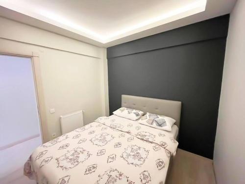 a bedroom with a bed with a white comforter at House in the center of Kadikoy in Istanbul